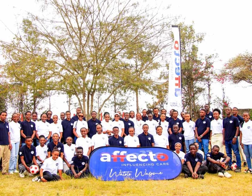 The Affecto community gathered behind an Affecto banner