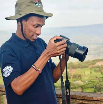 Peter Maina working with a camera outdoors